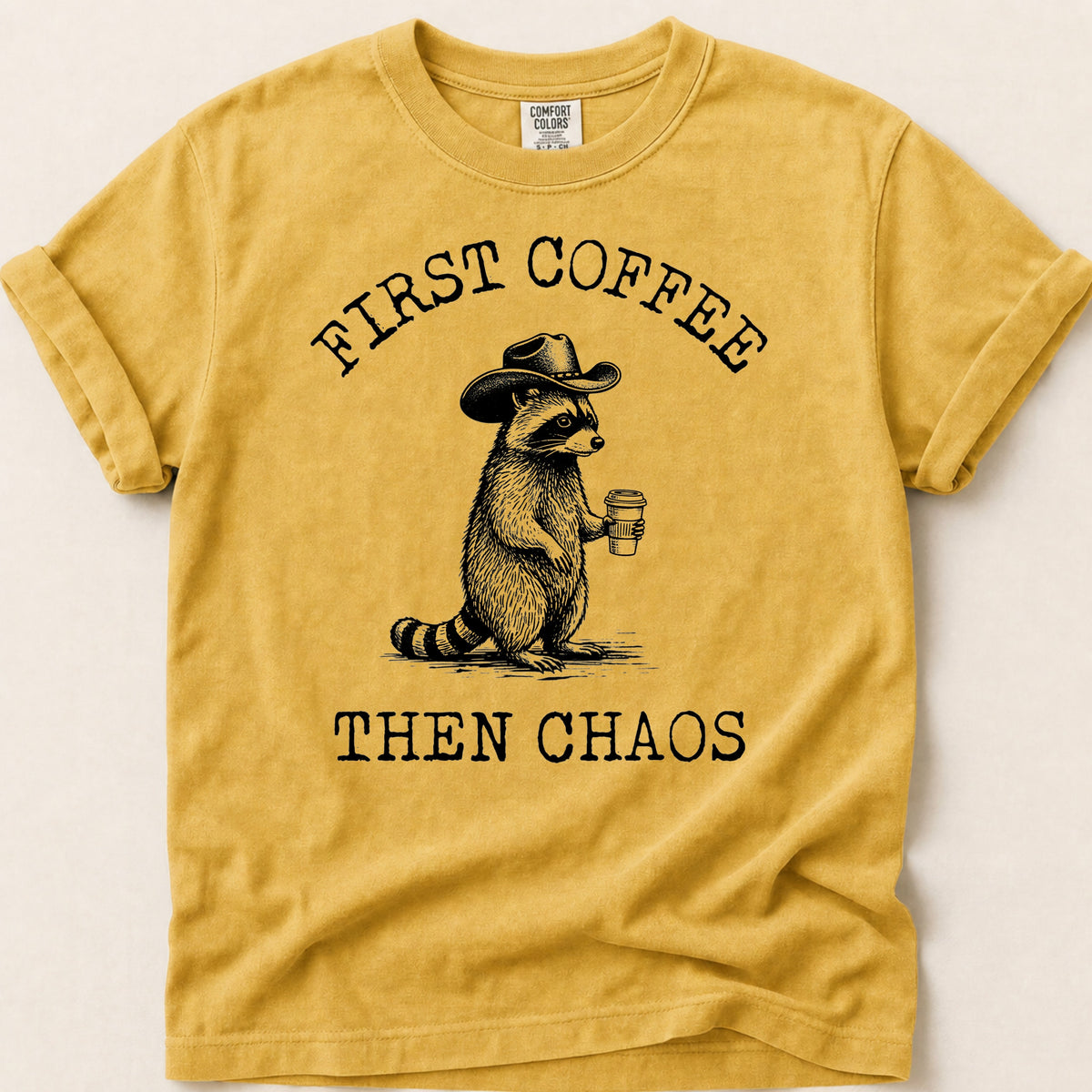 Coffee Chaos Raccoon T-shirt on Mustard