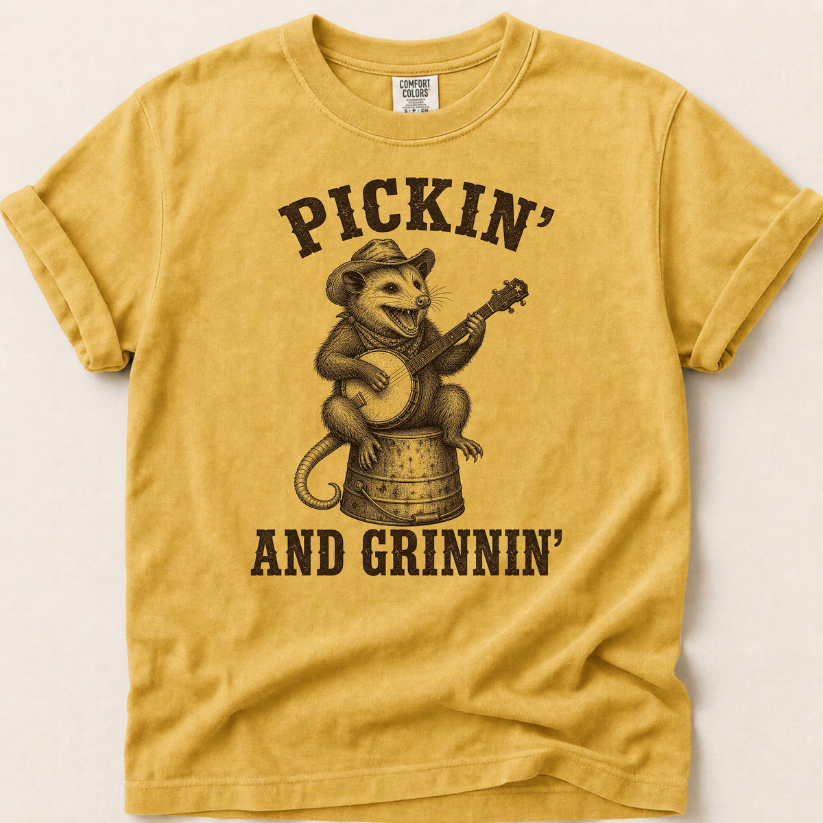 Pickin And Grinnin Possum T-shirt on Mustard